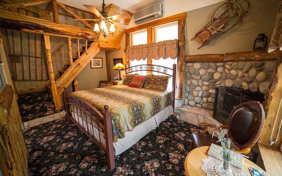 California River Rock Fireplace Warms The First Floor of the Sunstone Tower